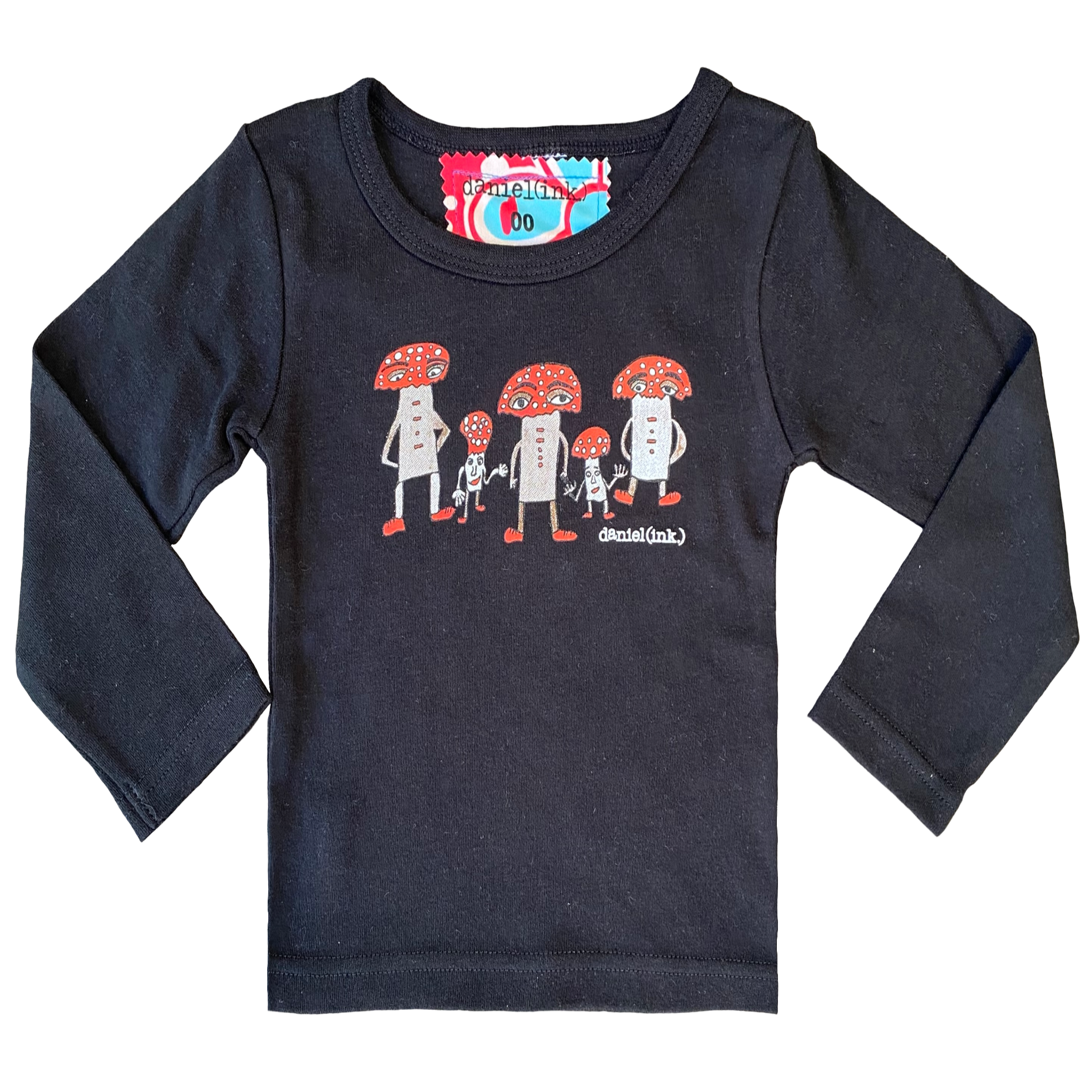 Black long sleeve babies' shirt featuring a hand drawn image of three large and two small mushroom humanoid figures. The mushroom figures have red heads and red shoes and red buttons which spell "magic" in morse code. The t-shirt has a red, white, and blue fabric label on the back of the neck.