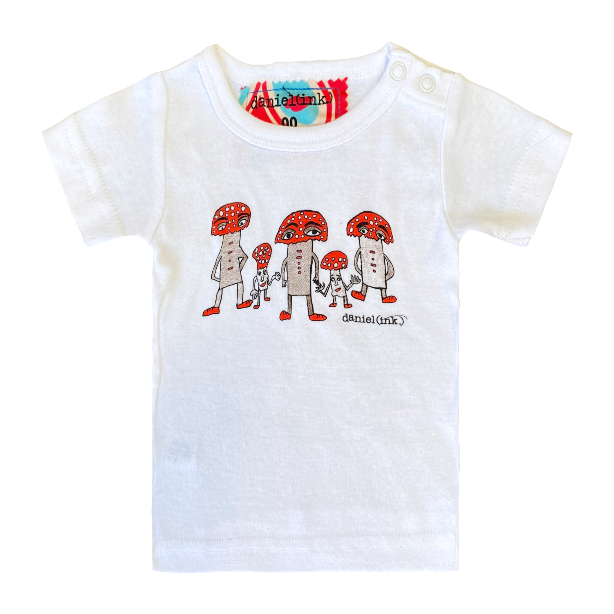White short sleeve babies' t-shirt featuring a hand drawn image of three large and two small mushroom humanoid figures. The mushroom figures have red heads and red shoes and red buttons which spell "magic" in morse code. The t-shirt has a red, white, and blue fabric label on the back of the neck and has two white press studs on the left shoulder.