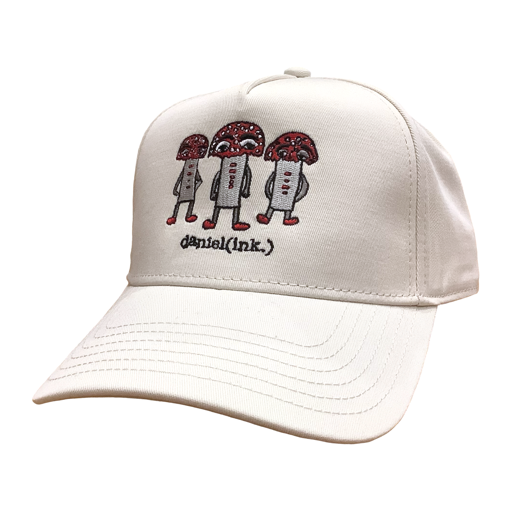 Ecru coloured snapback cap featuring an embroidered image of three large mushroom humanoid figures. The mushroom figures have red heads and red shoes and red buttons which spell "magic" in morse code. The name daniel(ink.) is embroidered in black thread underneath the mushroom figures.