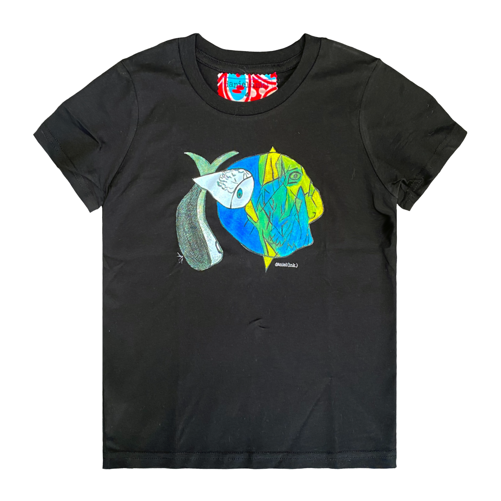 Black kids' t-shirt featuring an abstract drawing of three fishes swimming together. The design features a large yellow, green, and blue fish on the right; a small grey fish in the middle; and another larger grey and white fish on the left. This t-shirt has a red, white, and blue fabric label on the back of the neck.