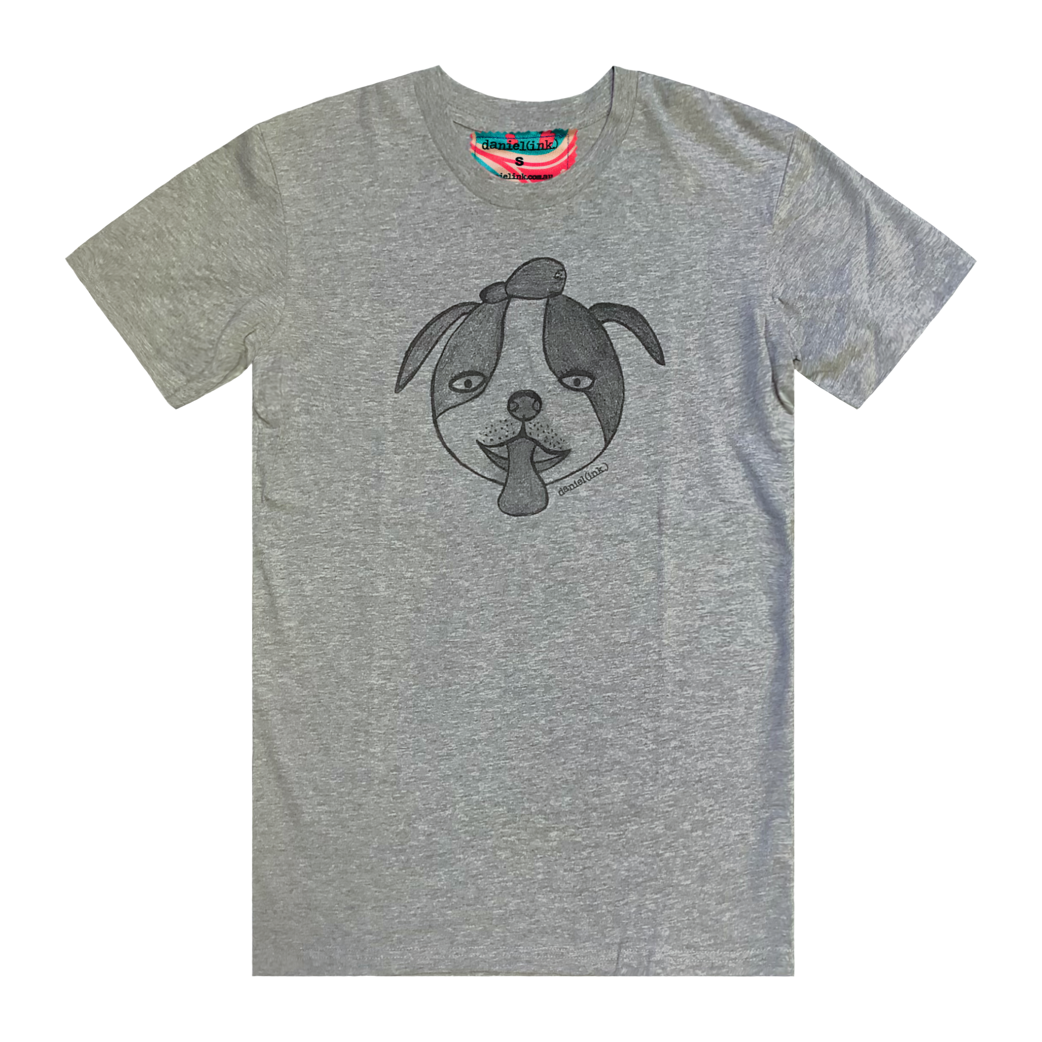 Grey short sleeve men's t-shirt featuring a hand drawn sketch of a dog’s face in black. The dog has a round head, floppy ears, wide eyes, and its tongue is sticking out. The t-shirt has a red, white, and blue fabric label on the back of the neck.