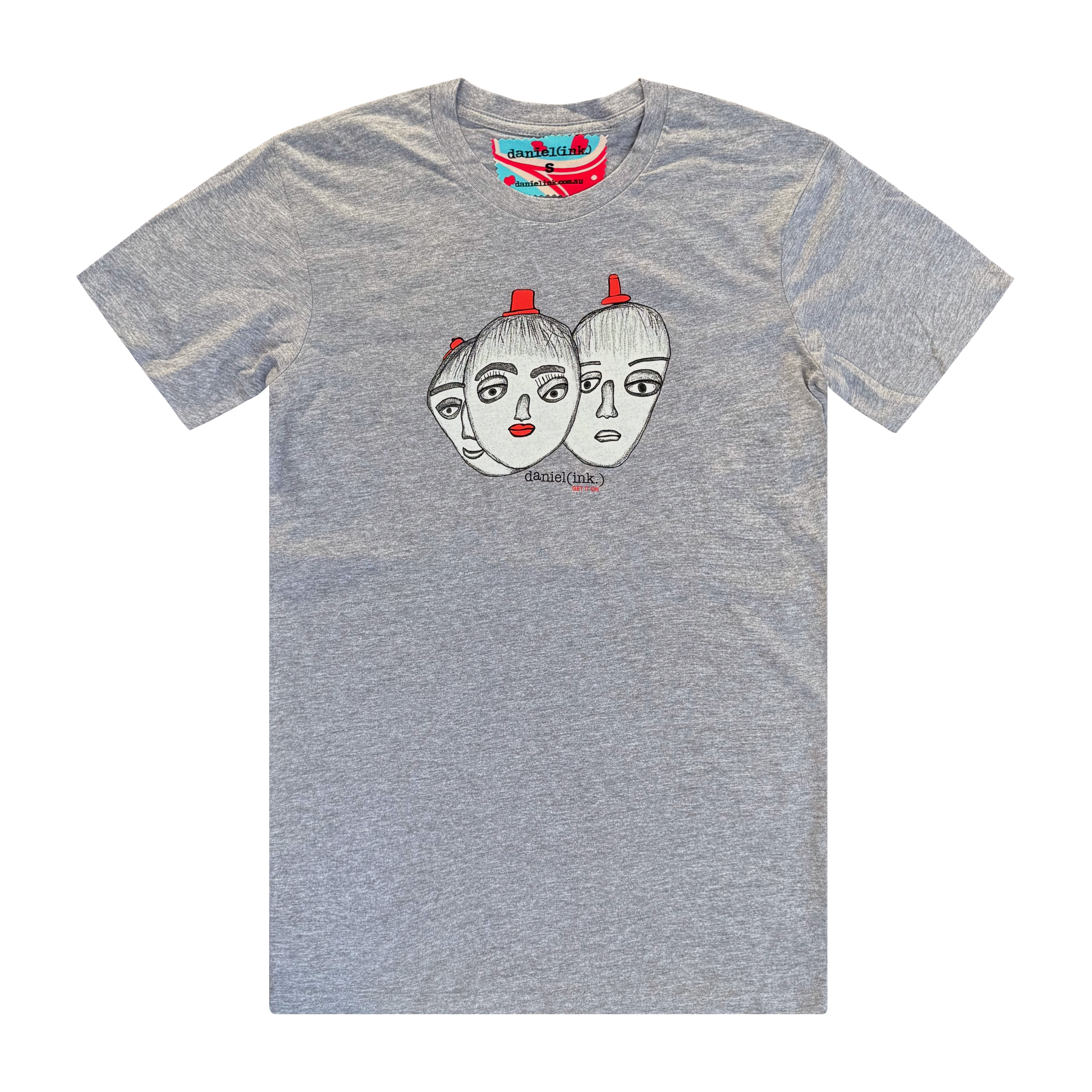 Men's grey t-shirt featuring a hand drawn sketch of three faces merged together. The three faces have red hats and the face in the middle has red lips. This t-shirt has a red, white, and blue fabric label on the back of the neck.