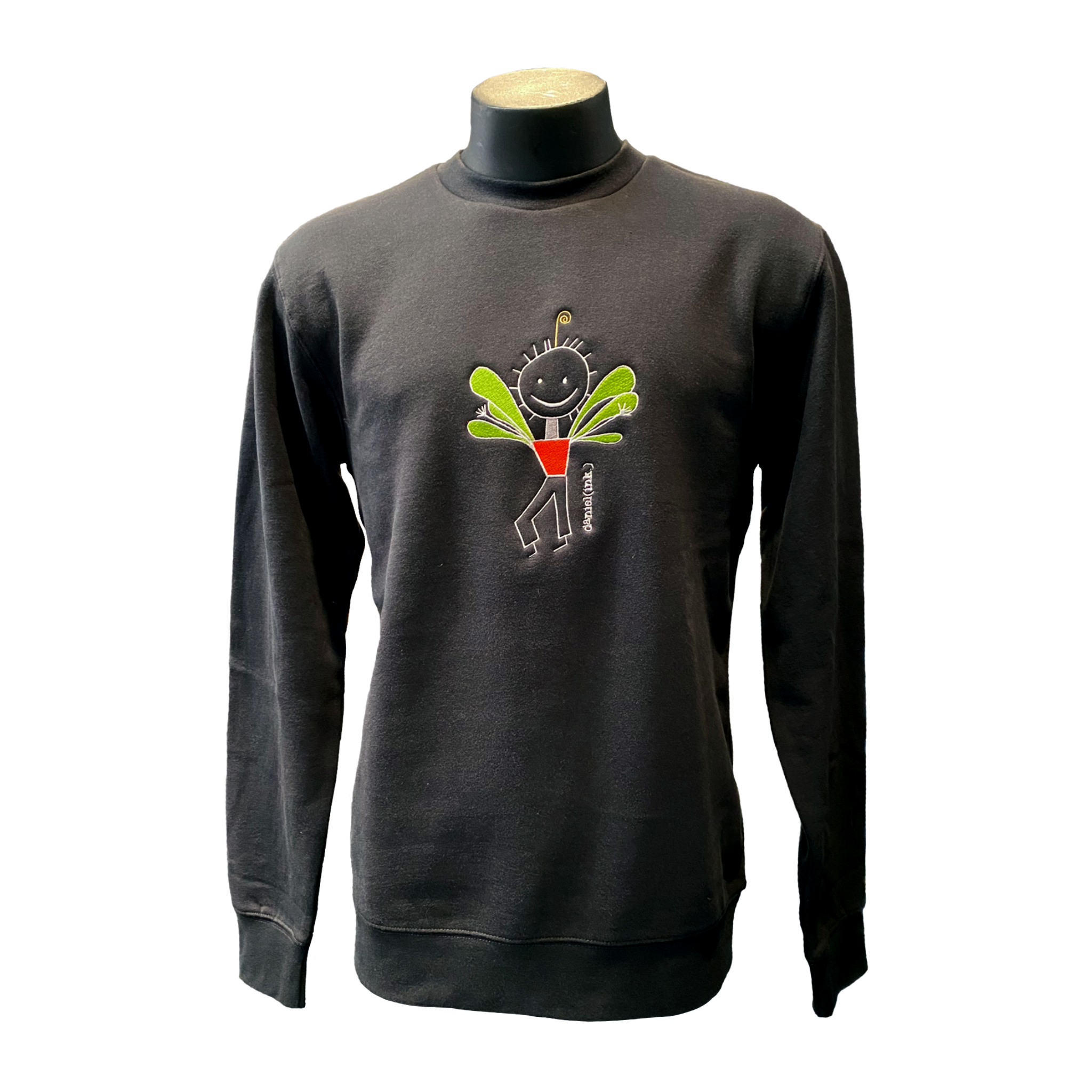 Unisex coal crew jumper featuring an embroidered image of a happy humanoid pot plant. The plant person is smiling and has a red plant pot-shaped torso with long legs and green leaves sprouting from the torso. The name daniel(ink.) is embroidered in silver thread next to the plant person.