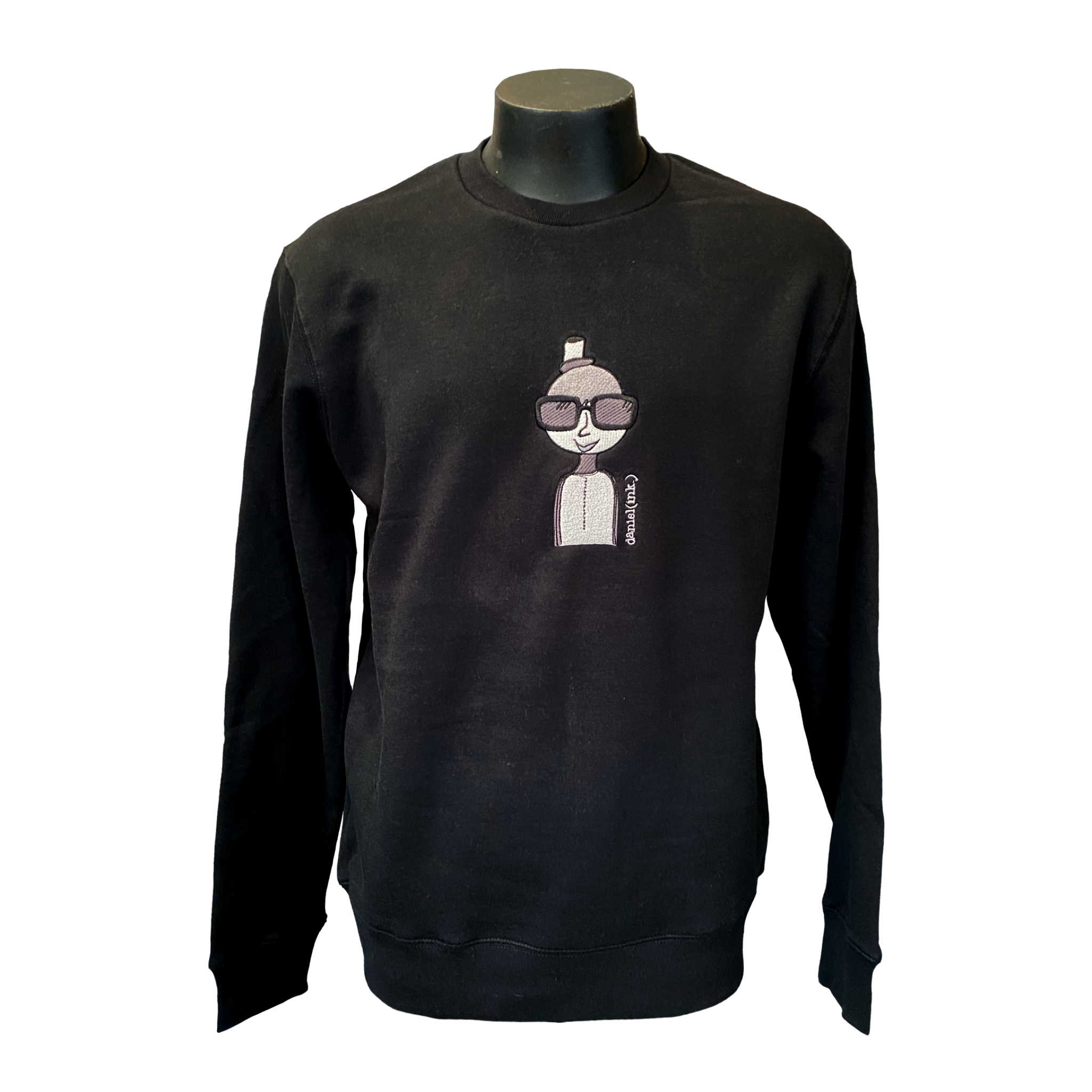 Unisex black crew jumper featuring an embroidered image of a person in silver and black. The person is wearing a small top hat and big sunglasses. The name daniel(ink.) is embroidered in silver thread to the right of the person.