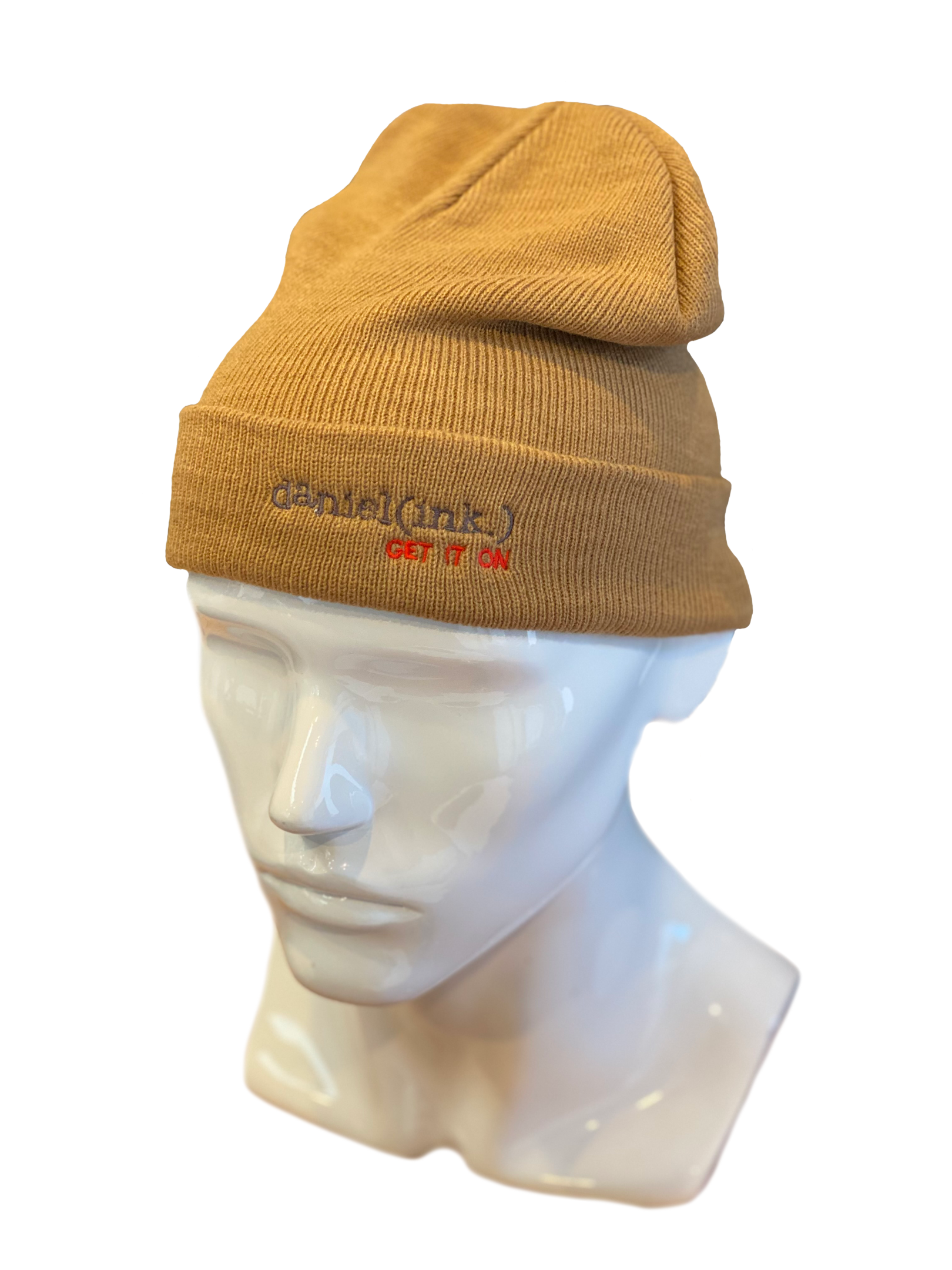 Cuff beanie in a camel colour with the daniel(ink.) logo embroidered on the cuff in dark silver and red.