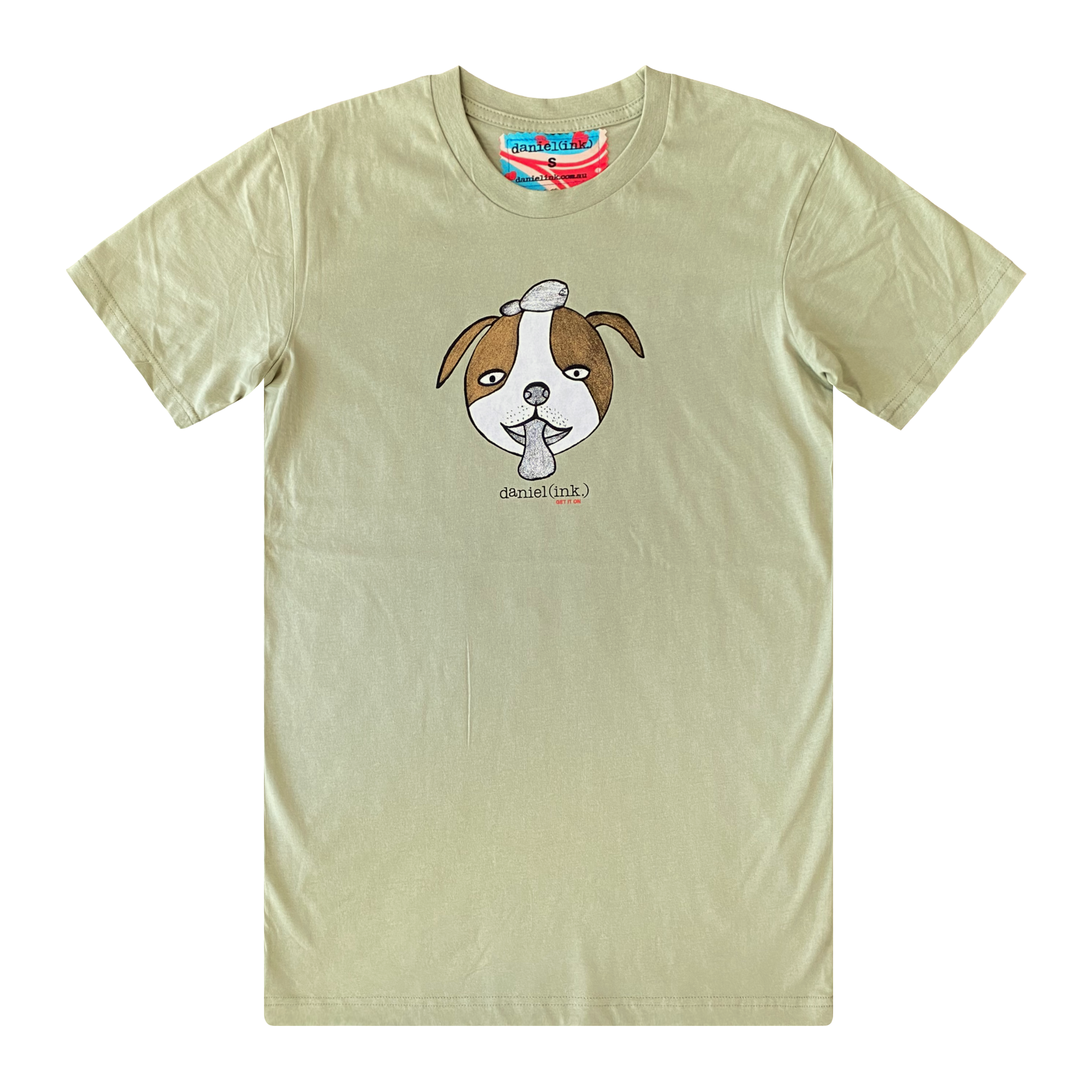 Men's pistachio colour t-shirt featuring a hand drawn sketch of a dog’s face in brown and white. The dog has a round head, floppy ears, wide eyes, and its tongue is sticking out. The t-shirt has a red, white, and blue fabric label on the back of the neck.